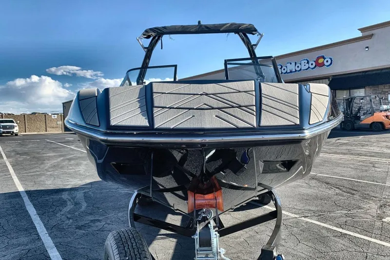 Slide: The Image of 2026 Moomba Mojo boat on trailer in parking lot, sunny day. - 8