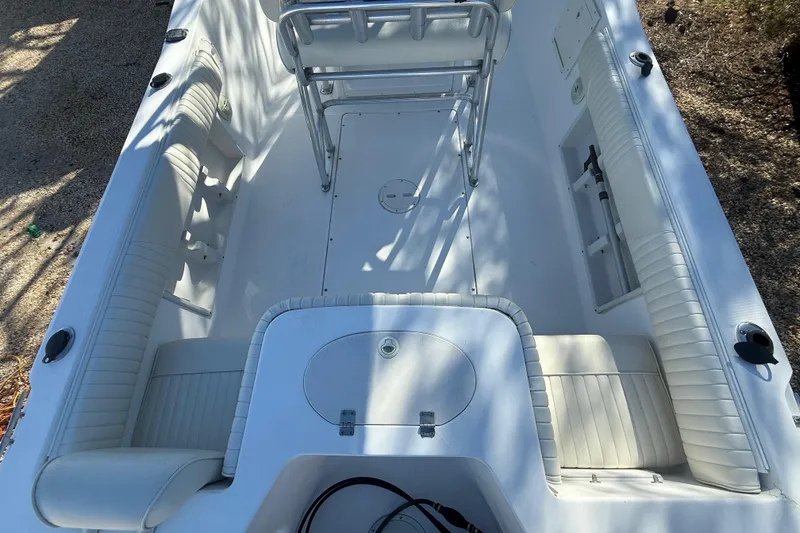Slide: The Image of 2007 Sea Hunt Triton 220 boat interior with white seating and storage compartments. - 11