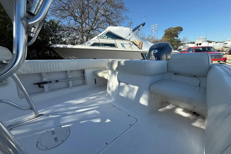 Slide: The Image of 2007 Sea Hunt Triton 220 boat interior with Yamaha 150 engine, docked outdoors. - 12