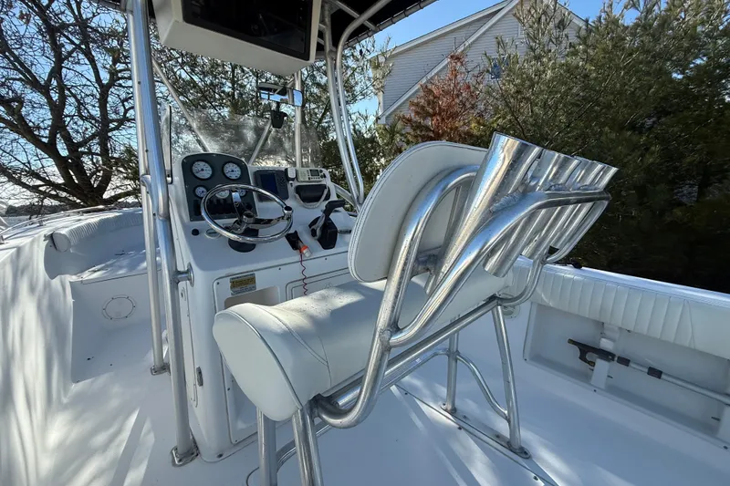 Slide: The Image of 2007 Sea Hunt Triton 220 boat interior with steering console and seating. - 2