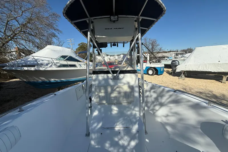 Slide: The Image of 2007 Sea Hunt Triton 220 boat docked, surrounded by other covered boats. - 3