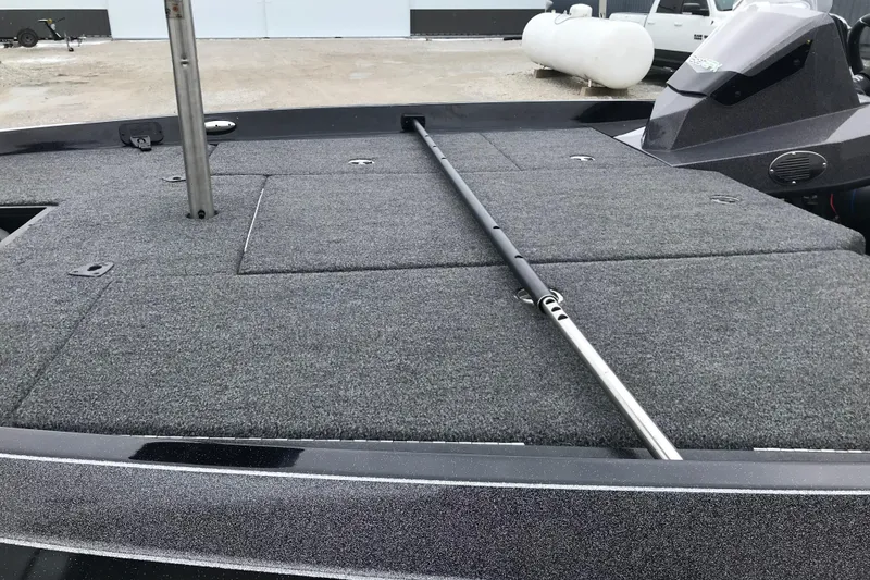 Slide: The Image of 2022 Ranger Z185 boat deck with gray carpet and storage compartments. - 23