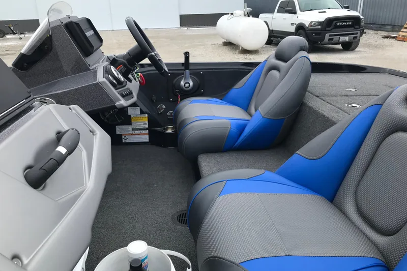 Slide: The Image of 2022 Ranger Z185 boat interior with blue and gray seats, steering console, and dashboard. - 25