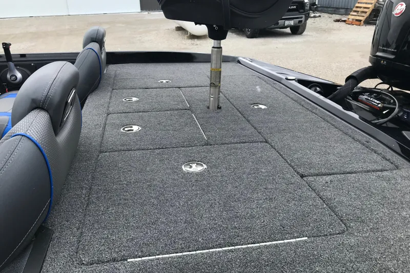 Slide: The Image of 2022 Ranger Z185 boat interior with carpeted deck and seating. - 26