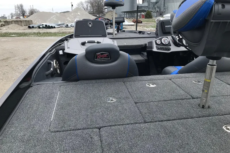 Slide: The Image of 2022 Ranger Z185 boat interior with seating and control panel, parked outdoors. - 27