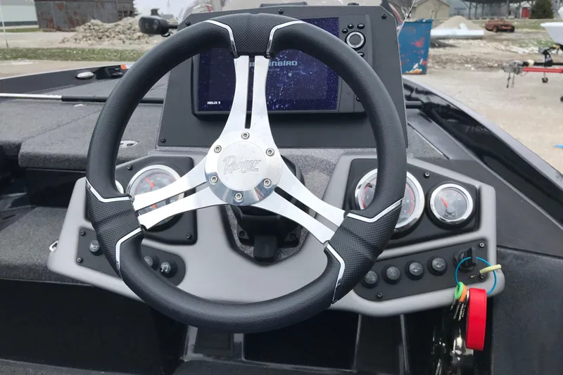 Slide: The Image of 2022 Ranger Z185 boat dashboard with steering wheel and navigation display. - 30