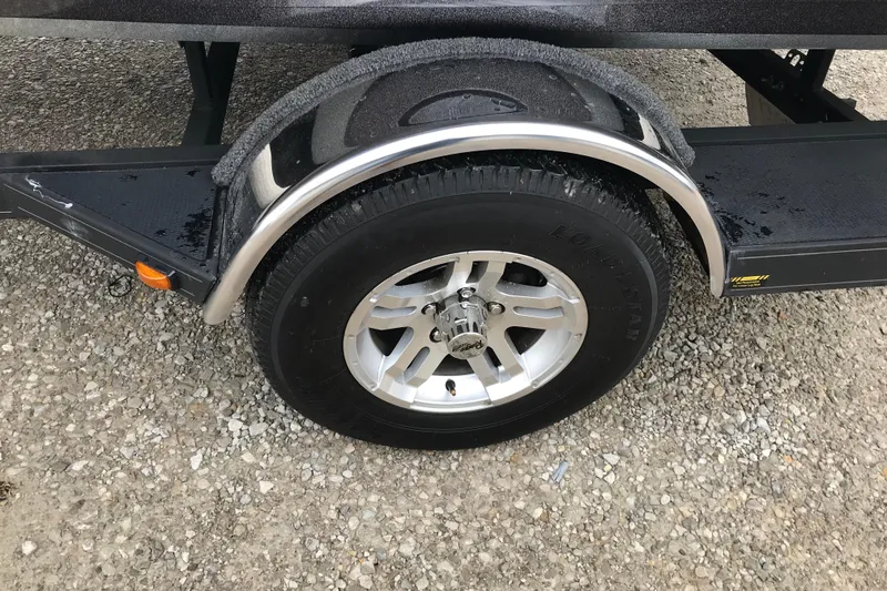 Slide: The Image of 2022 Ranger Z185 trailer wheel on gravel surface, featuring a silver rim and black tire. - 38