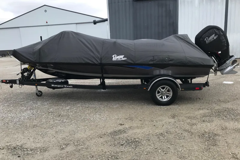 Slide: The Image of 2022 Ranger Z185 boat covered on trailer, parked outdoors. - 44
