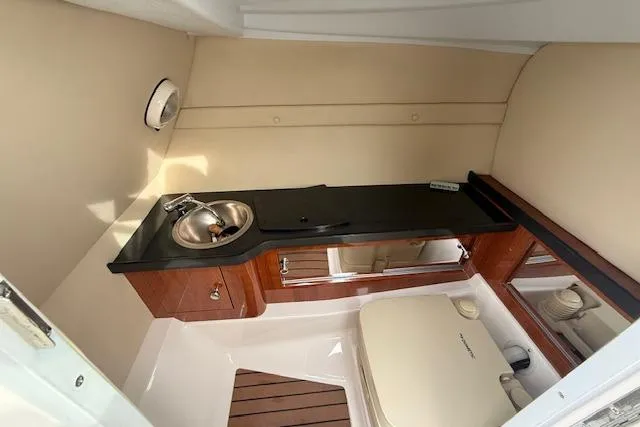 Slide: The Image of Interior of 2012 Regal 24 FasDeck boat with sink and seating area. - 12