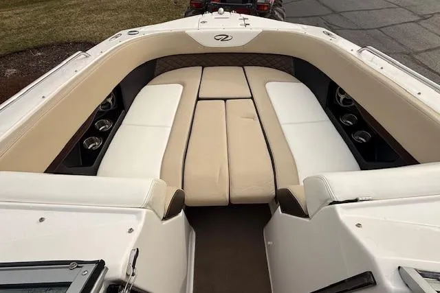 Slide: The Image of 2012 Regal 24 FasDeck boat interior with beige and white seating. - 15