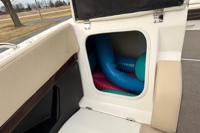 Slide: The Image of Storage compartment on a 2012 Regal 24 FasDeck boat with colorful pool noodles. - 16