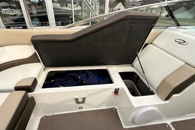 Slide: The Image of 2012 Regal 24 FasDeck boat interior with open storage compartments and seating. - 20