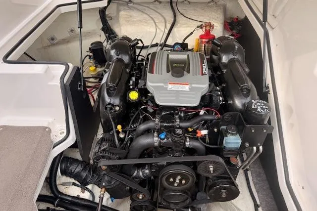 Slide: The Image of Engine compartment of a 2012 Regal 24 FasDeck boat, showcasing detailed mechanics. - 24