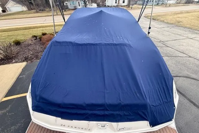 Slide: The Image of Covered 2012 Regal 24 FasDeck boat with blue tarp in driveway. - 31