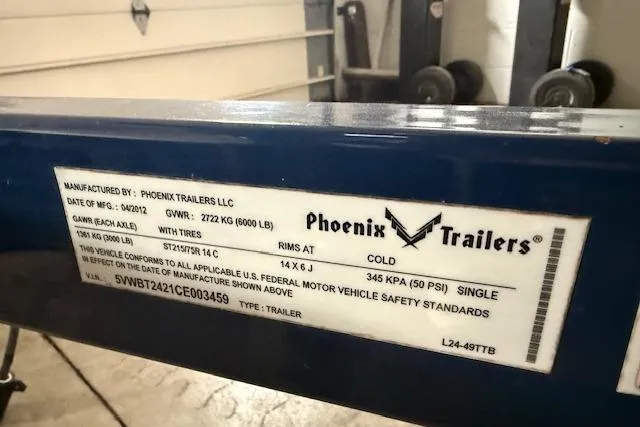Slide: The Image of Label on a Phoenix Trailers LLC, 2012 Regal 24 FasDeck, showing specifications and safety standards. - 33