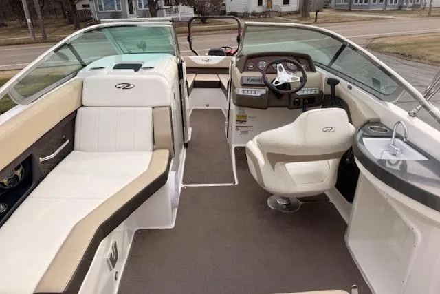 Slide: The Image of 2012 Regal 24 FasDeck boat interior with seating, steering wheel, and dashboard. - 5