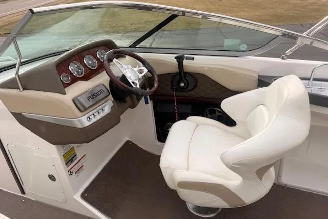 Slide: The Image of Interior of 2012 Regal 24 FasDeck boat with steering wheel and captain's chair. - 6