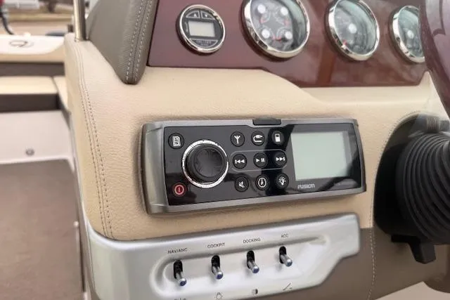 Slide: The Image of Control panel of a 2012 Regal 24 FasDeck boat with audio system and switches. - 8