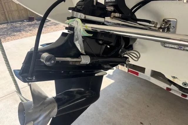 Slide: The Image of 2007 Formula 353 FASTech boat propeller and engine detail in a driveway setting. - 11