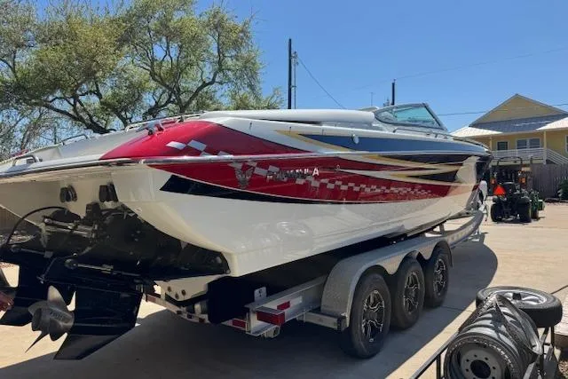 Slide: The Image of 2007 Formula 353 FASTech boat on trailer, vibrant red and white design, parked outdoors. - 14