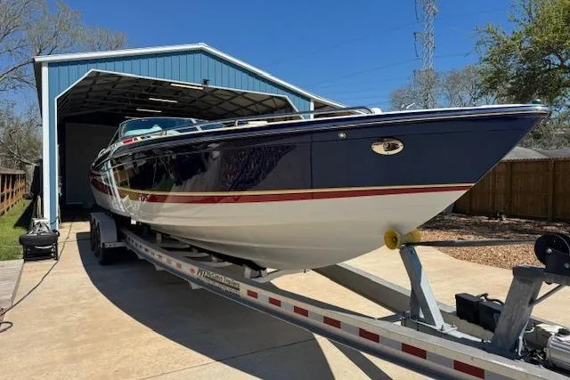Slide: The Image of 2007 Formula 353 FASTech boat on trailer in front of blue garage. - 16