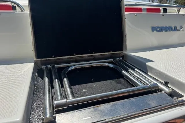 Slide: The Image of 2007 Formula 353 FASTech boat with open storage compartment and metal ladder. - 18