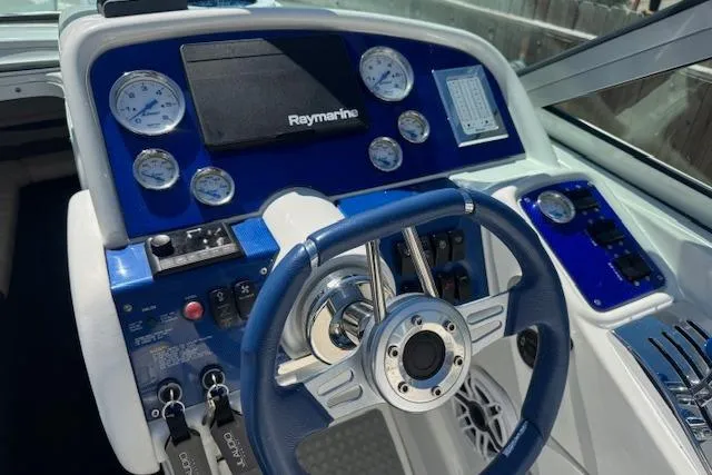 Slide: The Image of 2007 Formula 353 FASTech boat dashboard with blue accents and Raymarine navigation system. - 20