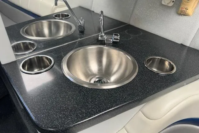 Slide: The Image of 2007 Formula 353 FASTech boat interior with dual stainless steel sinks and black countertop. - 44