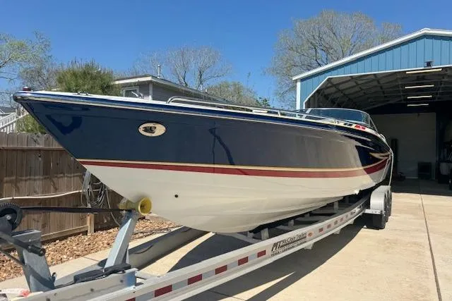 Slide: The Image of 2007 Formula 353 FASTech boat on trailer, blue and white with red stripe, parked outdoors. - 5