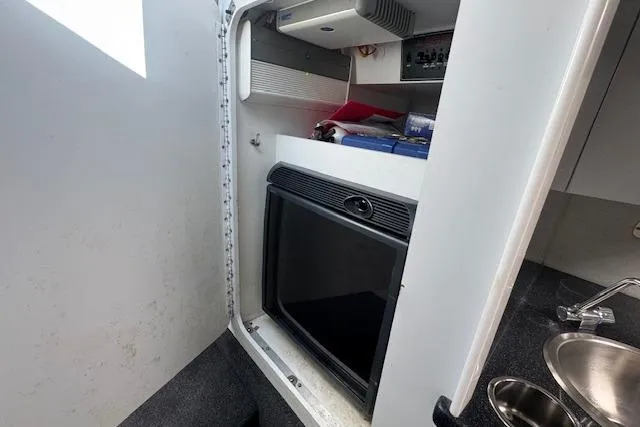Slide: The Image of Interior of a 2007 Formula 353 FASTech boat with compact kitchenette and storage. - 51