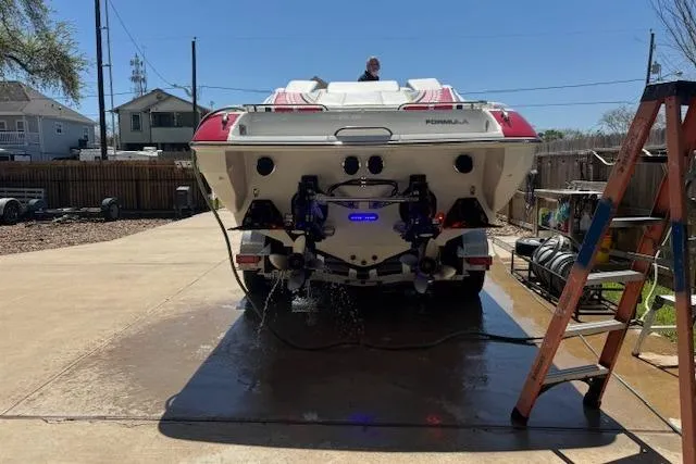 Slide: The Image of 2007 Formula 353 FASTech boat being washed on a driveway with a ladder nearby. - 56