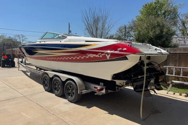 Slide: The Image of 2007 Formula 353 FASTech speedboat on a trailer, featuring vibrant graphics. - 7
