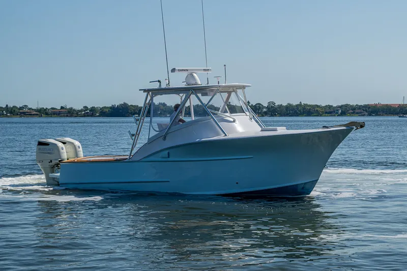 Slide: The Image of 2019 Custom Carolina Custom Express boat cruising on calm waters. - 39