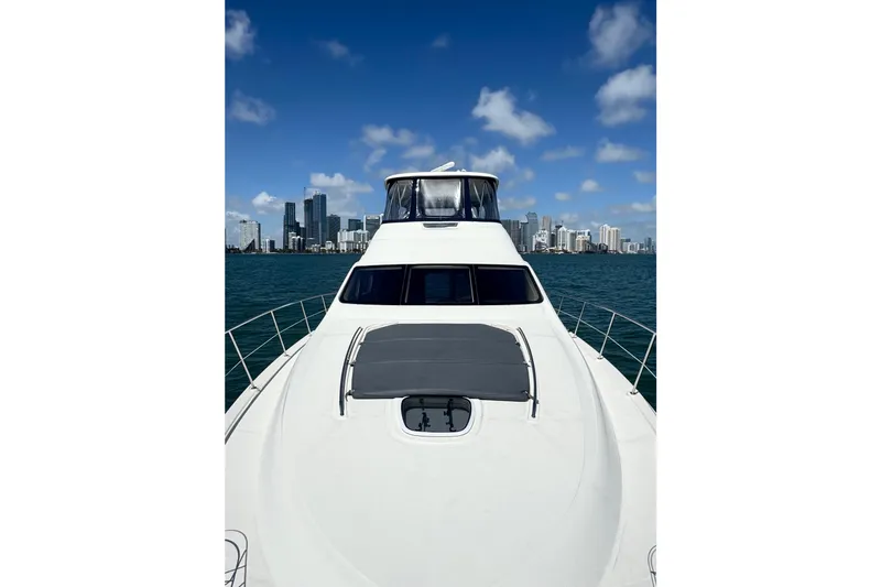 Slide: The Image of 2005 Sea Ray 550 Sedan Bridge yacht cruising with city skyline in background. - 13