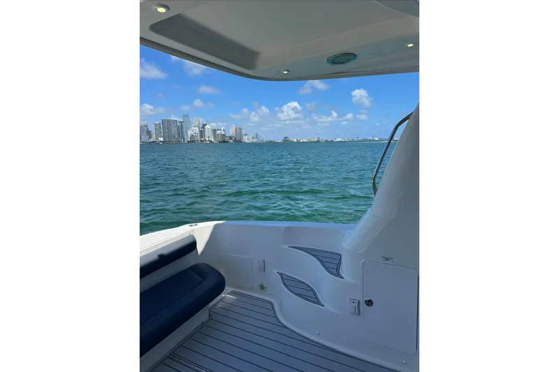 Slide: The Image of 2005 Sea Ray 550 Sedan Bridge yacht with city skyline view on the water. - 16