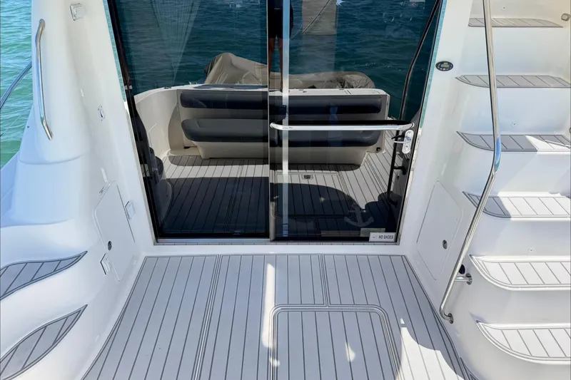 Slide: The Image of 2005 Sea Ray 550 Sedan Bridge yacht deck with sliding glass door and stairs. - 18