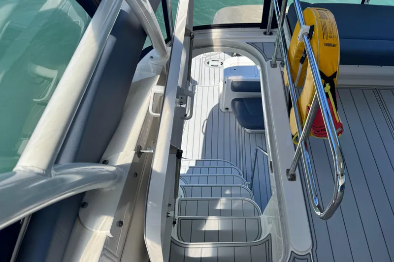 Slide: The Image of 2005 Sea Ray 550 Sedan Bridge deck with safety railings and life jacket. - 20