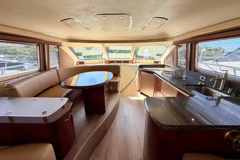Slide: The Image of Luxurious interior of 2005 Sea Ray 550 Sedan Bridge yacht with modern kitchen and seating area. - 24