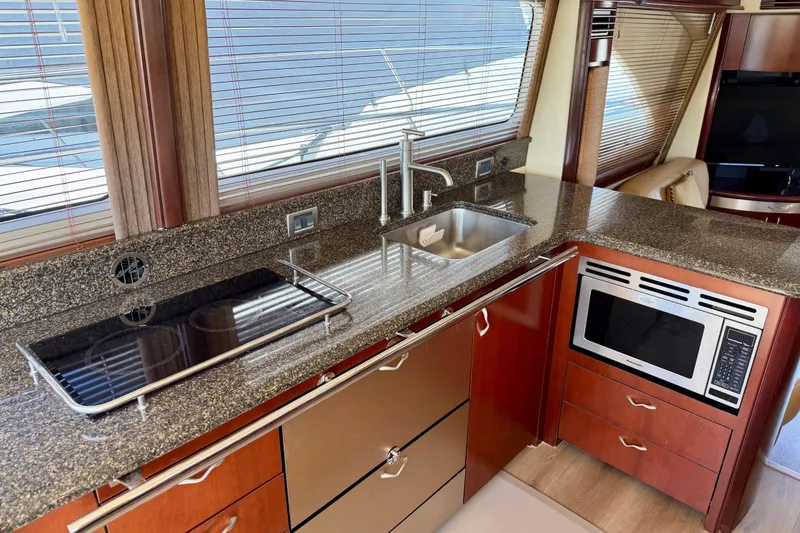 Slide: The Image of Luxurious kitchen interior of 2005 Sea Ray 550 Sedan Bridge yacht with modern appliances. - 26