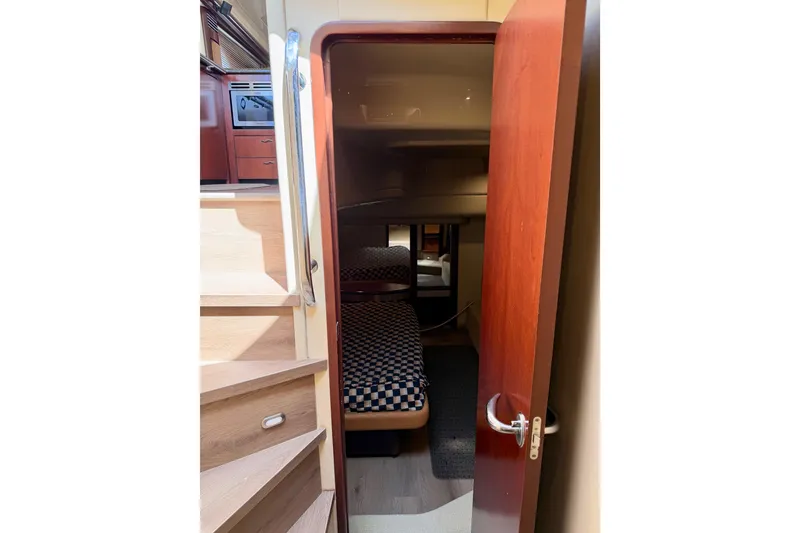 Slide: The Image of Interior cabin view of 2005 Sea Ray 550 Sedan Bridge yacht with stairs and cozy sleeping area. - 28