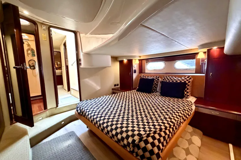 Slide: The Image of Luxurious 2005 Sea Ray 550 Sedan Bridge yacht bedroom with elegant decor and ample lighting. - 3