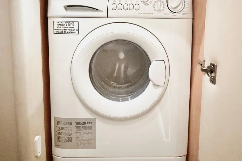 Slide: The Image of Washing machine inside 2005 Sea Ray 550 Sedan Bridge yacht laundry area. - 35