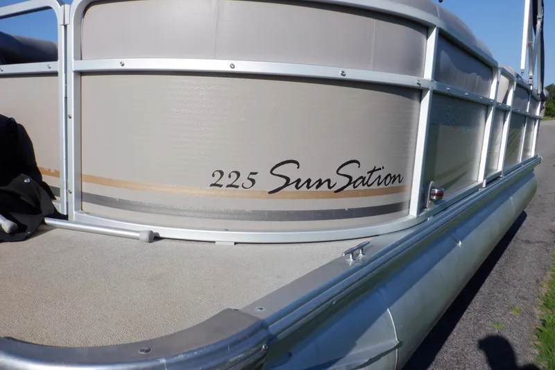 Slide: The Image of 2009 Premier 225 Sunsation LTD pontoon boat, side view with logo and railing. - 13