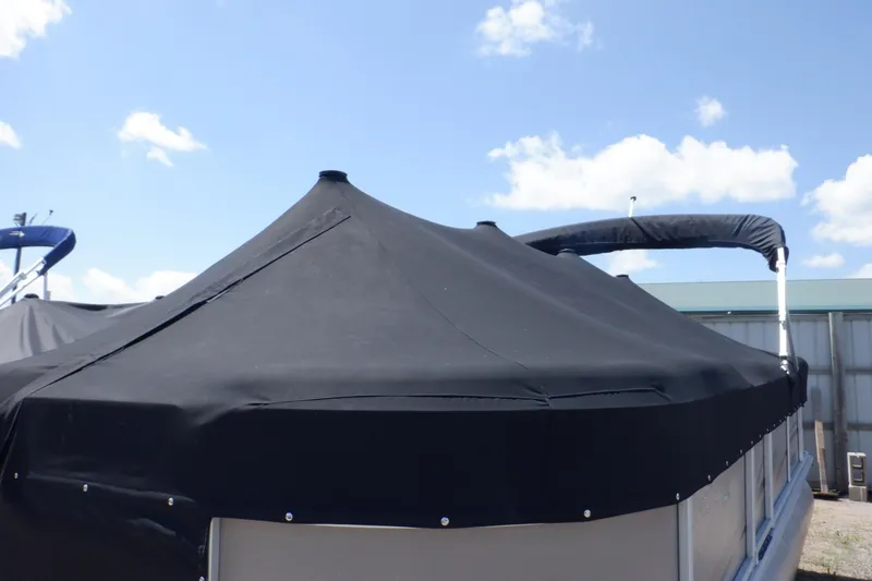 Slide: The Image of 2009 Premier 225 Sunsation LTD pontoon boat with black cover under blue sky. - 16