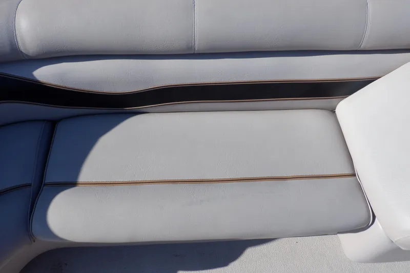 Slide: The Image of 2009 Premier 225 Sunsation LTD boat seating with white upholstery and brown accents. - 32