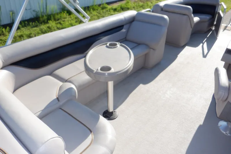Slide: The Image of 2009 Premier 225 Sunsation LTD pontoon boat interior with gray seating and table. - 44