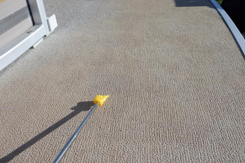 Slide: The Image of Textured boat deck of 2009 Premier 225 Sunsation LTD with a yellow-handled tool. - 46