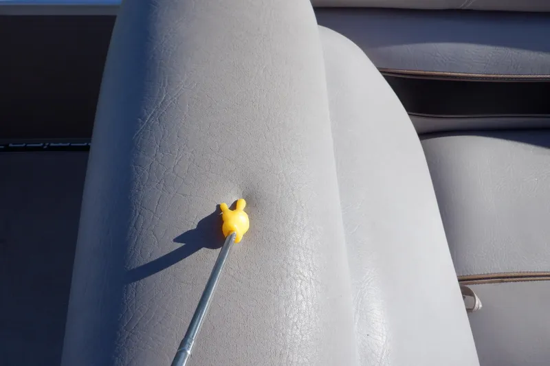 Slide: The Image of Close-up of 2009 Premier 225 Sunsation LTD boat seat with a yellow tool on it. - 48