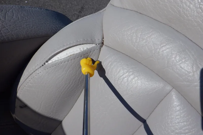 Slide: The Image of Torn seat upholstery on 2009 Premier 225 Sunsation LTD boat with yellow tool pointing. - 49