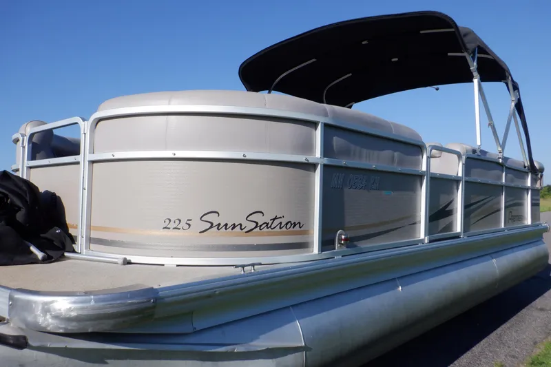 Slide: The Image of 2009 Premier 225 Sunsation LTD pontoon boat with canopy, docked under clear blue sky. - 6